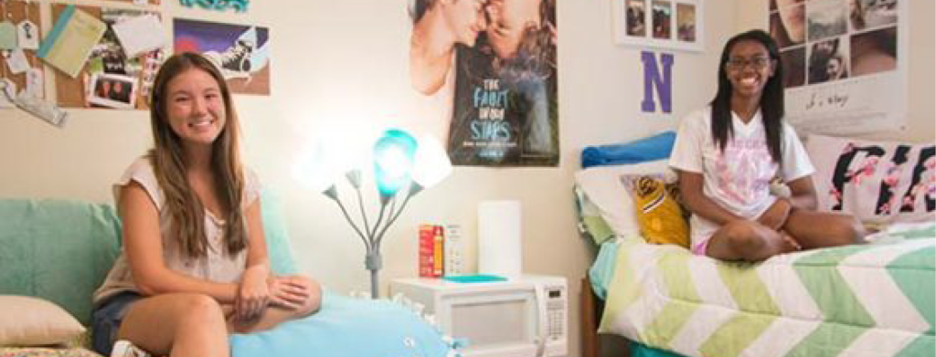 students sitting on beds in room