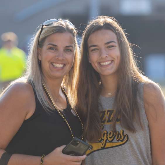 A Mizzou student and her mother smile at the camera