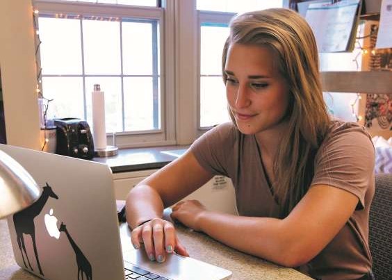 Student on laptop in dorm room