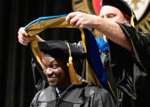Student receiving hood at graduation