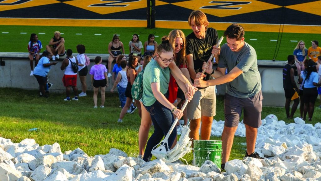 Students paint the M at Faurot field, one of campus's welcome week traditions.