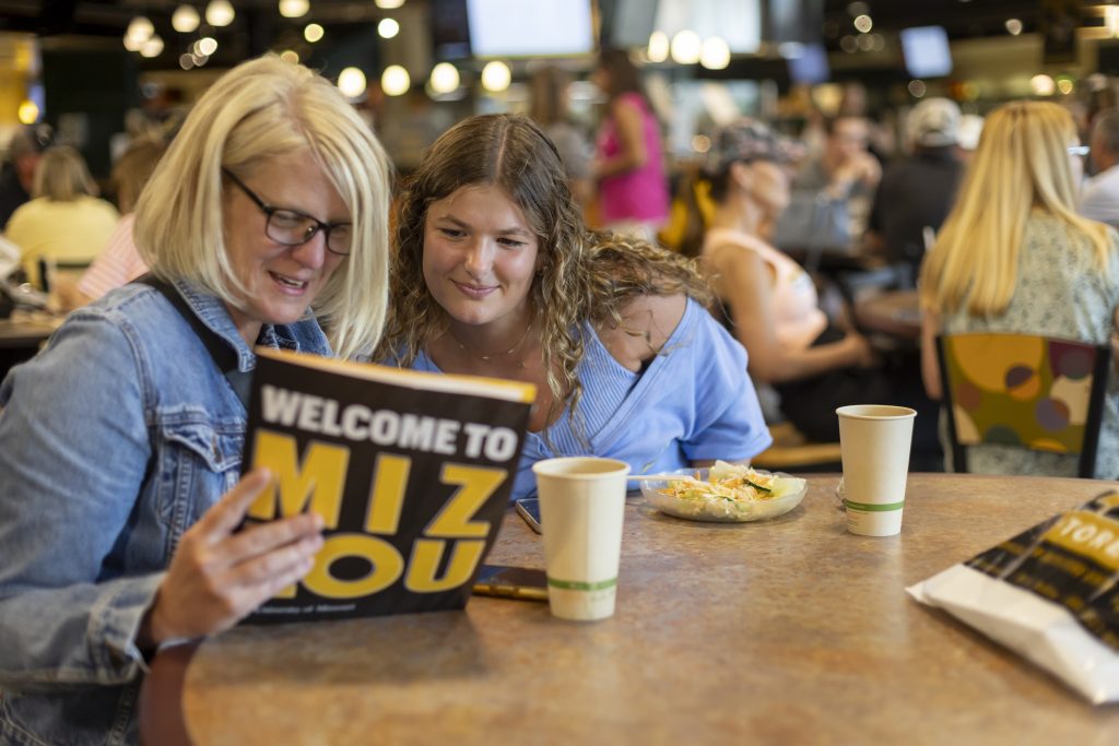 Students and families eat together at Plaza 900 dining hall during